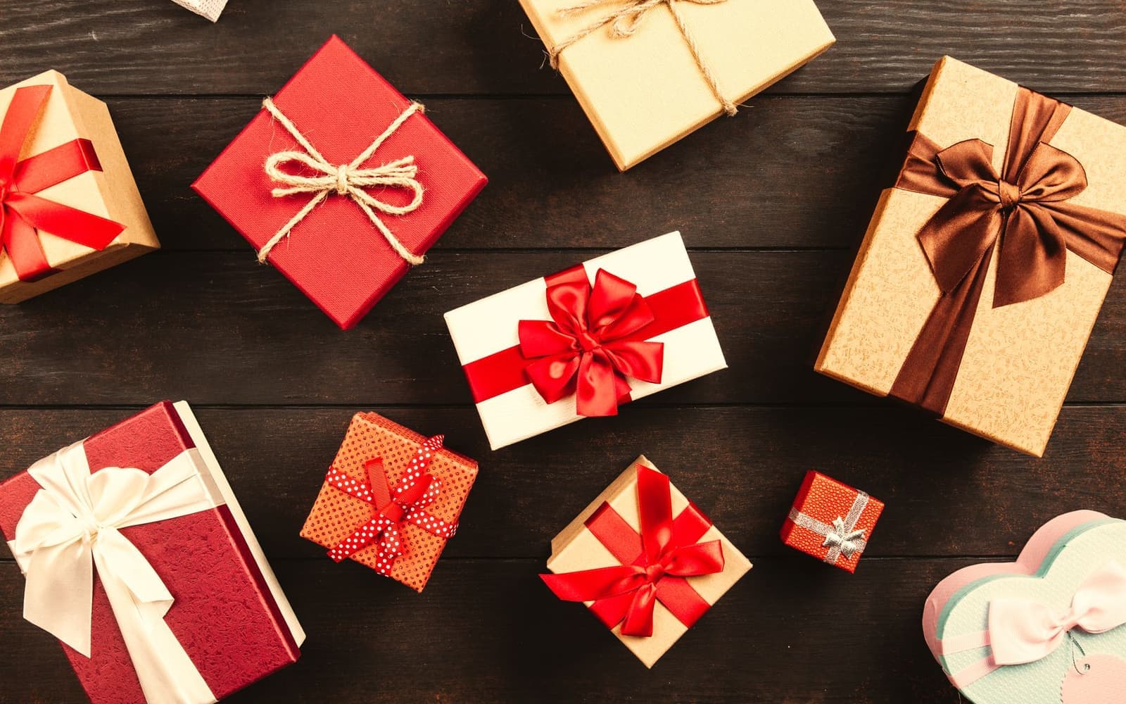 Wrapped gift boxes with ribbons on a wooden table